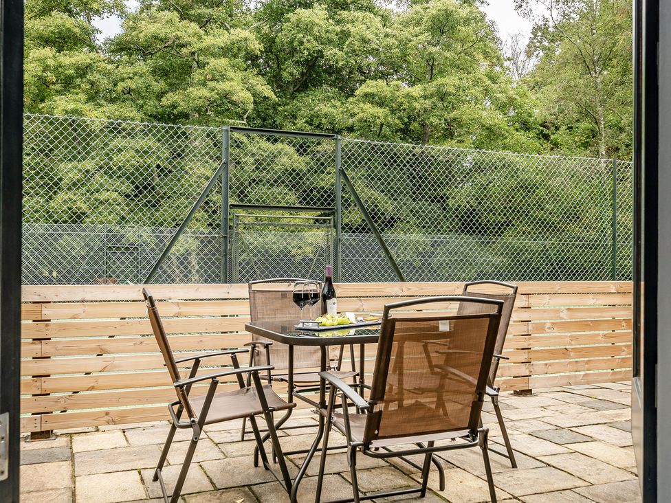 An outdoor patio with a table and chairs at The Annex in Wimborne Minster