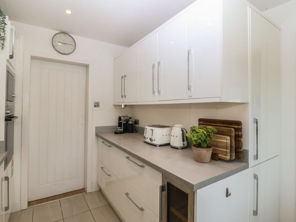 A kitchen with cabinets and appliances at Trem Ynys near Abersoch