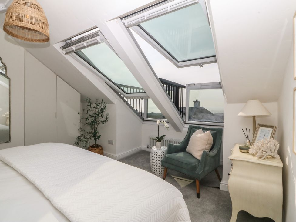 A bedroom with skylights and a plant at Trem Ynys in Mynytho near Abersoch