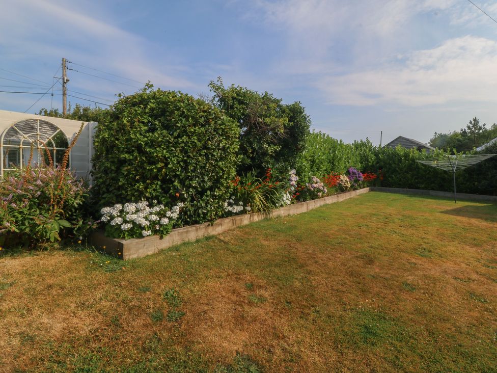 A garden with flowers and plants at Trem Ynys Mynytho near Abersoch