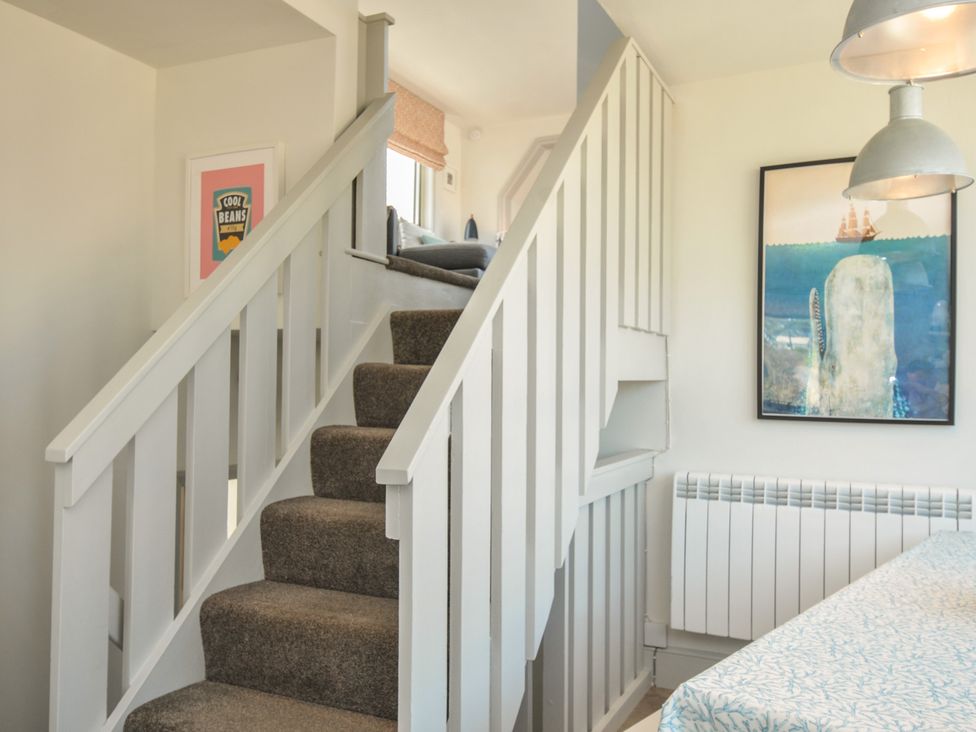 A staircase with a picture and radiator at The Lookout in Polzeath