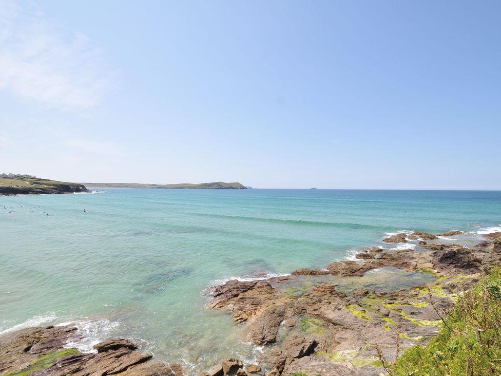 A view of the sea with surf and rocky shore at The Lookout Polzeath