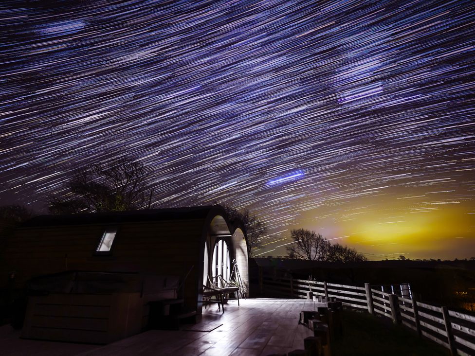 A cabin with a deck and a tripod at Creuddyn Llanfihangel-y-Creuddyn near Aberystwyth