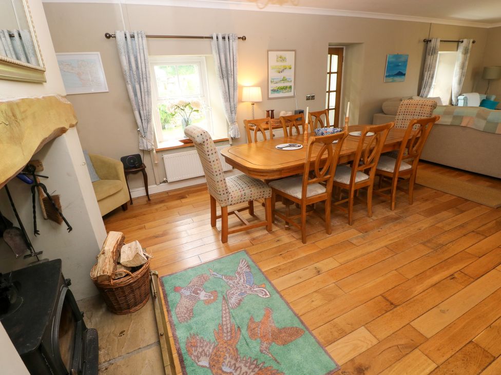 A dining room with a table and chairs at North Studdock Cottage Angle near Pembroke