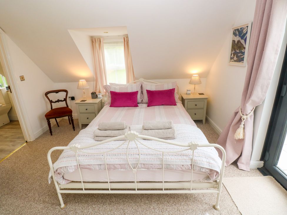 A bedroom with a bed and bedside table at North Studdock Cottage Angle near Pembroke