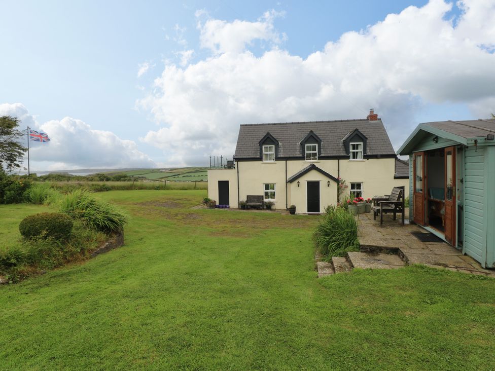 An outdoor view of a house with a garden at North Studdock Cottage, Angle near Pembroke