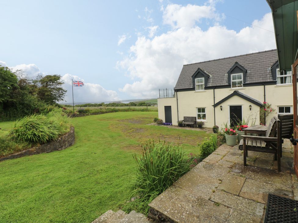 An outdoor area with a building and a flag at North Studdock Cottage Angle near Pembroke