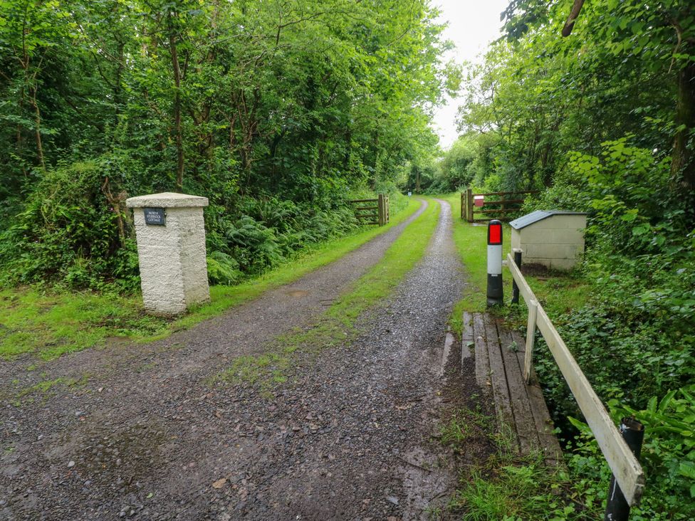 A pathway with gates and a sign at North Studdock Cottage Angle near Pembroke