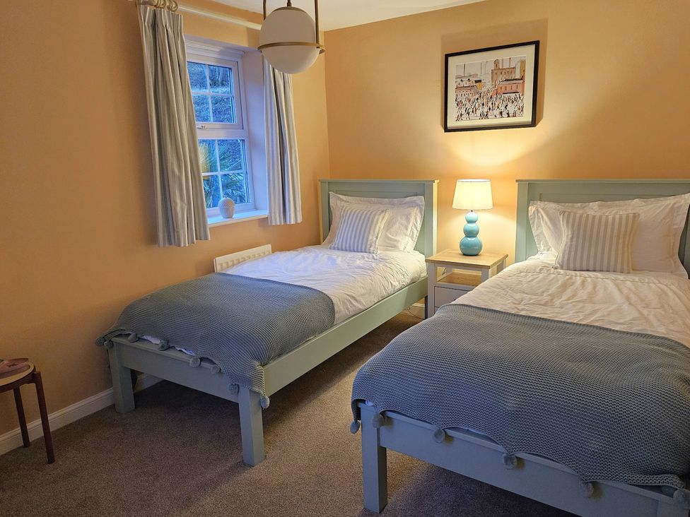 A bedroom with two single beds and a nightstand at The Milne in Todmorden