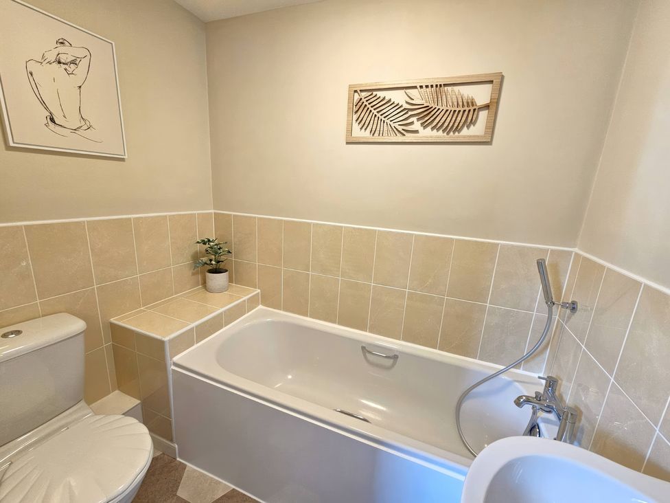 A bathroom with a bathtub and toilet at The Milne in Todmorden
