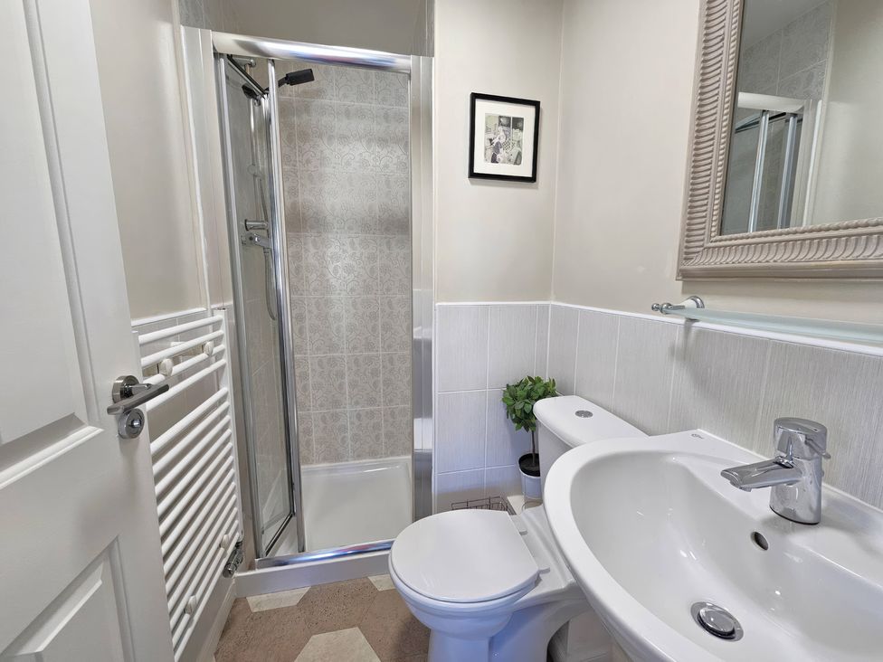 A bathroom with a shower, sink, and toilet at The Milne in Todmorden