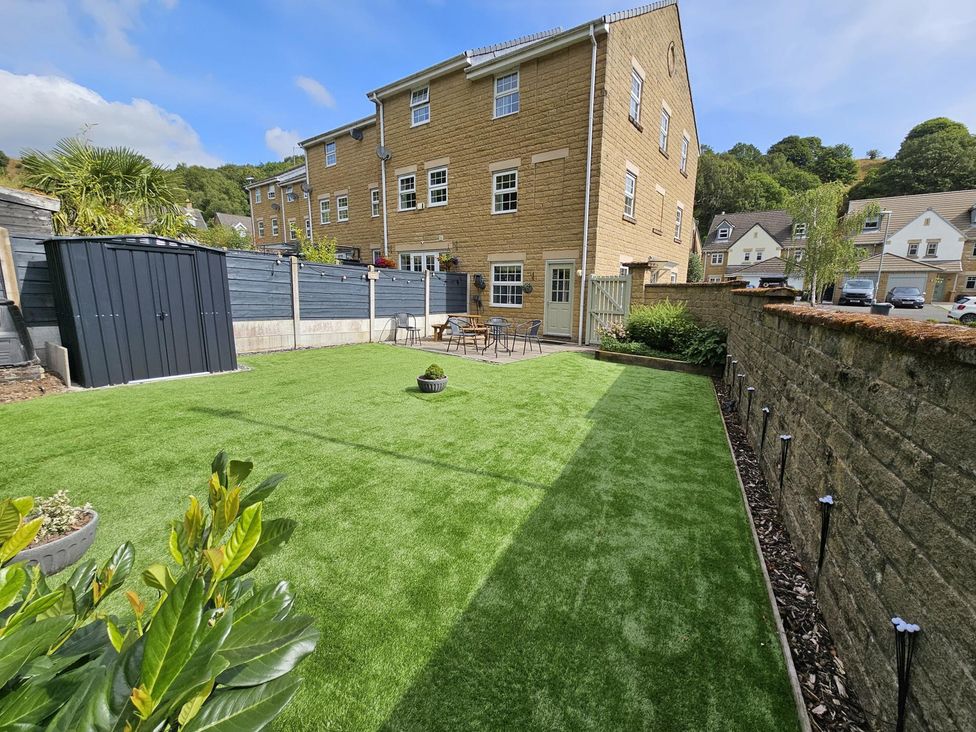 A garden with a patio table and chairs at The Milne in Todmorden