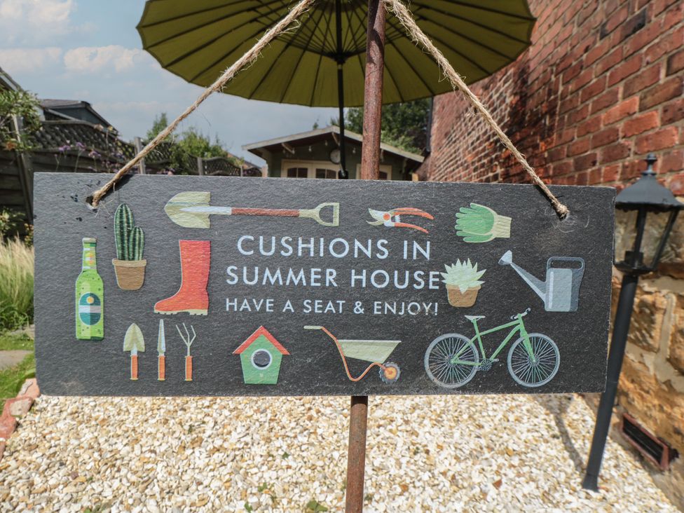 A sign indicating cushions in summer house at Red Grouse Cottage in Guisborough