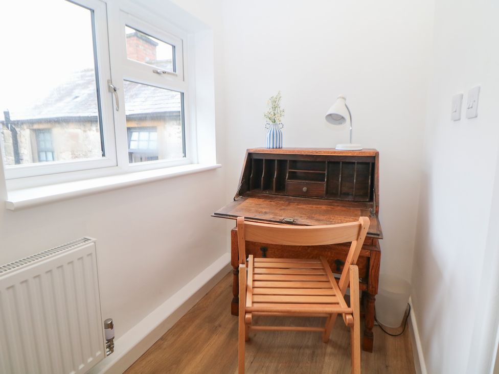 A study room with a desk and chair at East Bank Cottage in Winster
