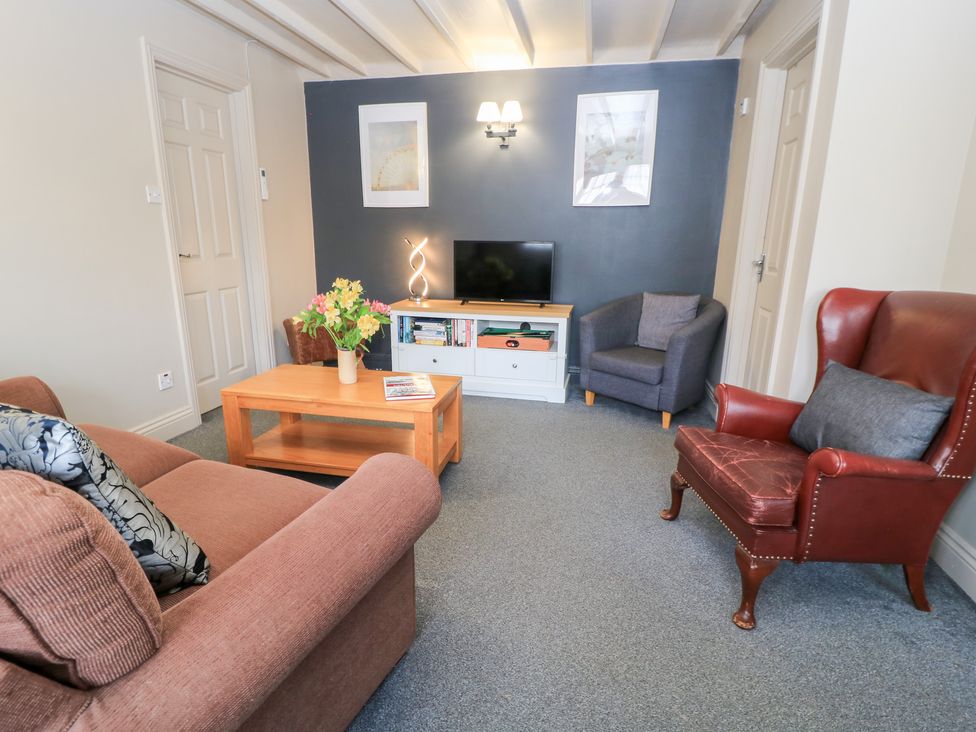 A living room with a sofa and coffee table at Paddock Cottage Nr Malmesbury