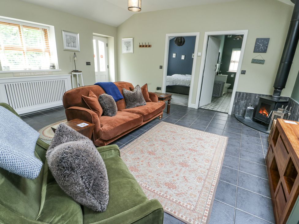 A living room with two sofas and a fireplace at The Old Tannery Beaumaris