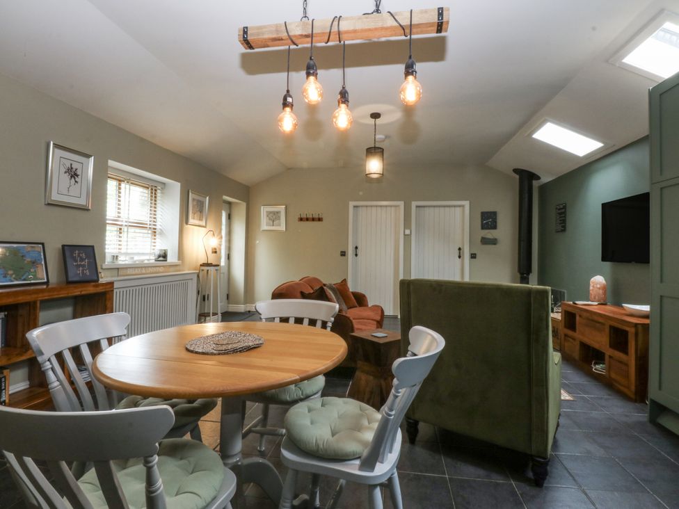 A living room with a table and chairs at The Old Tannery Beaumaris