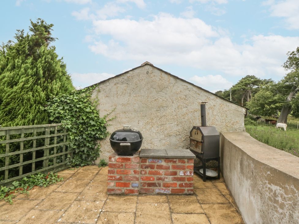 A patio area with a grill and barbecue at The Old Tannery Beaumaris