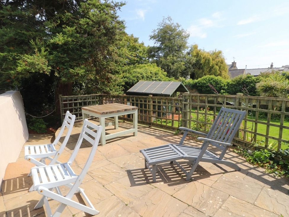 A garden with outdoor furniture and greenery at The Old Tannery Beaumaris