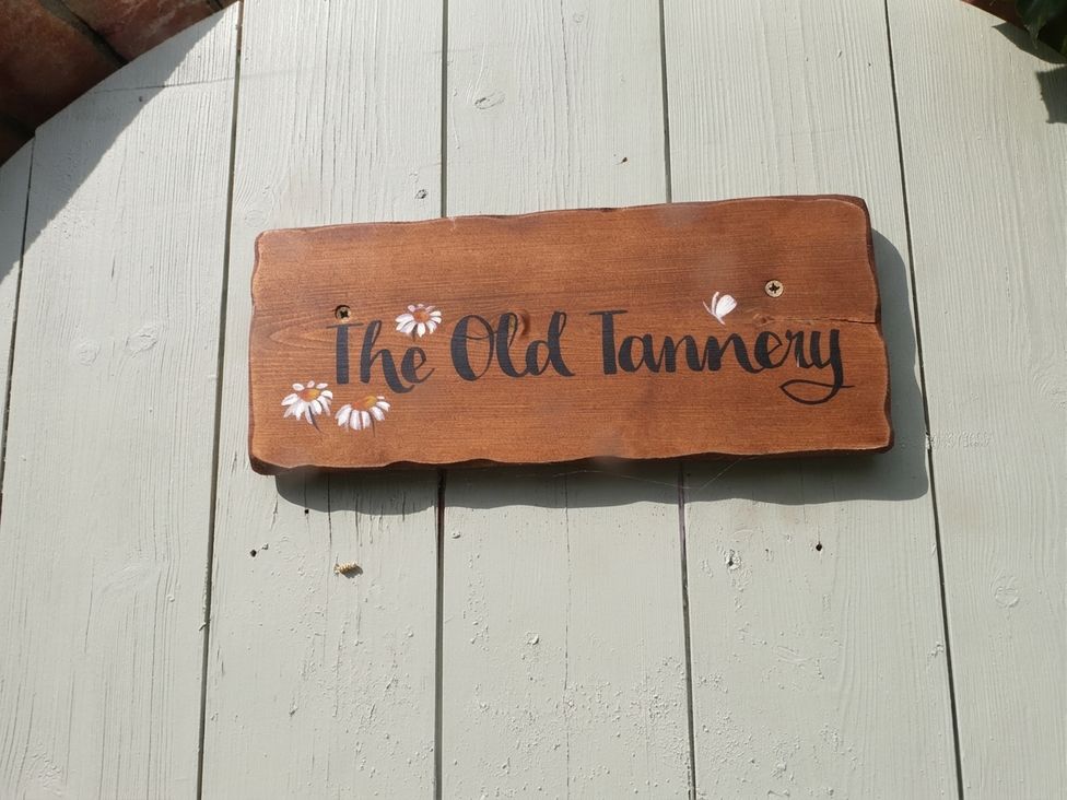 A wooden sign with the name The Old Tannery at Beaumaris