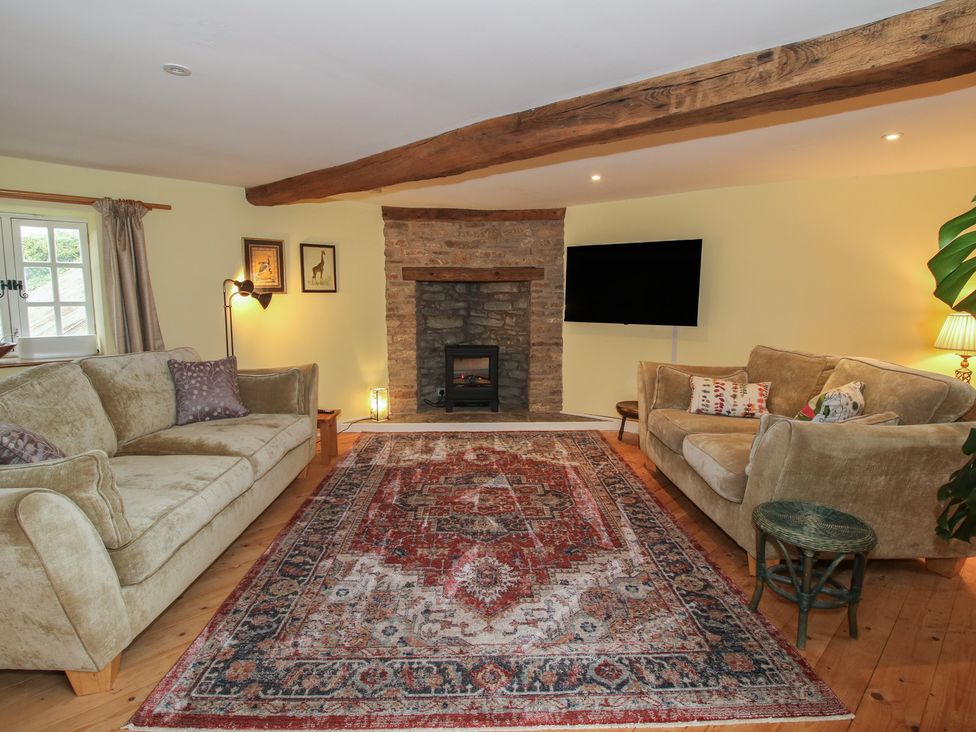 A living room with a fireplace and two sofas at Malt House