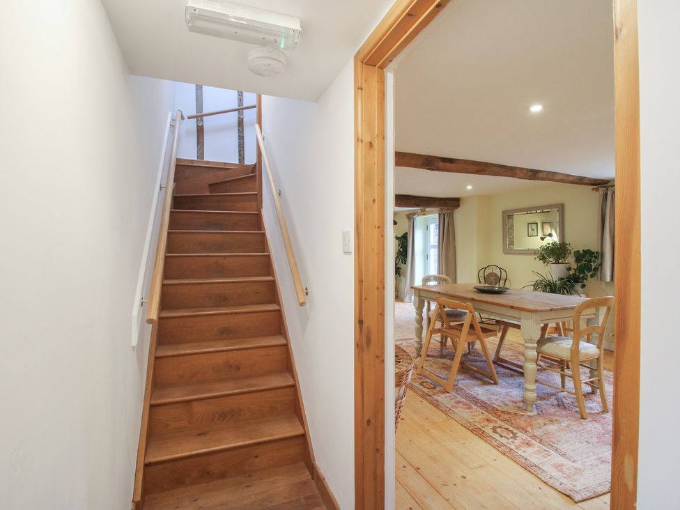 A hallway with stairs leading to another room at Malt House