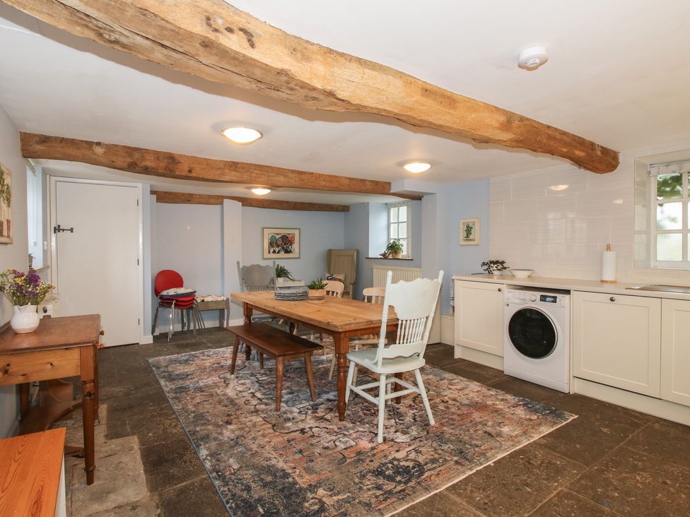 A kitchen with a dining table and washing machine at Malt House