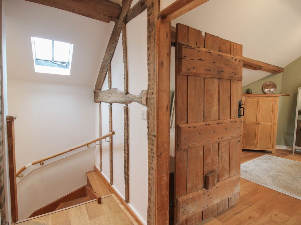 A staircase leading to a wooden door in a hallway at Malt House