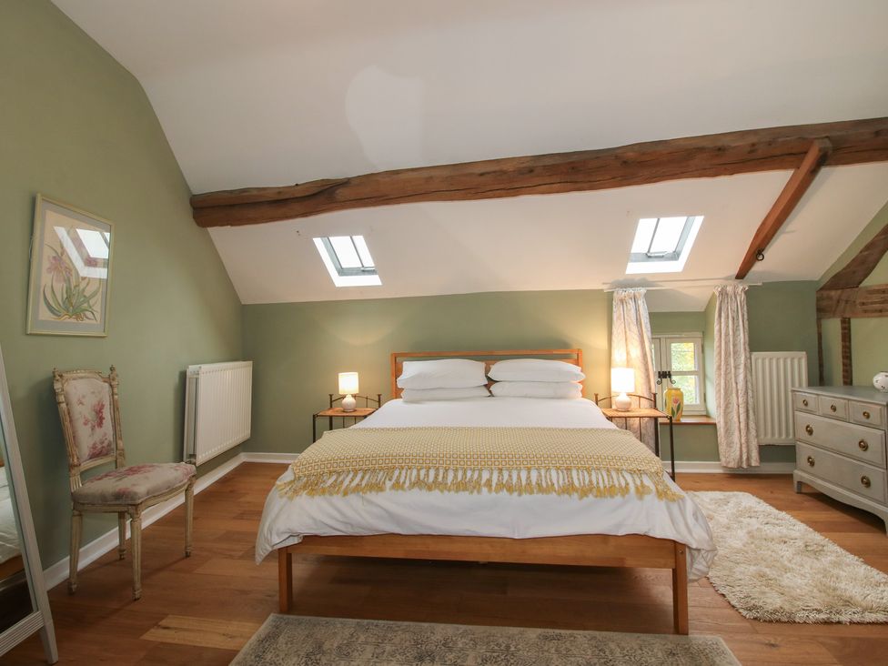 A bedroom with a bed and a dresser at Malt House 