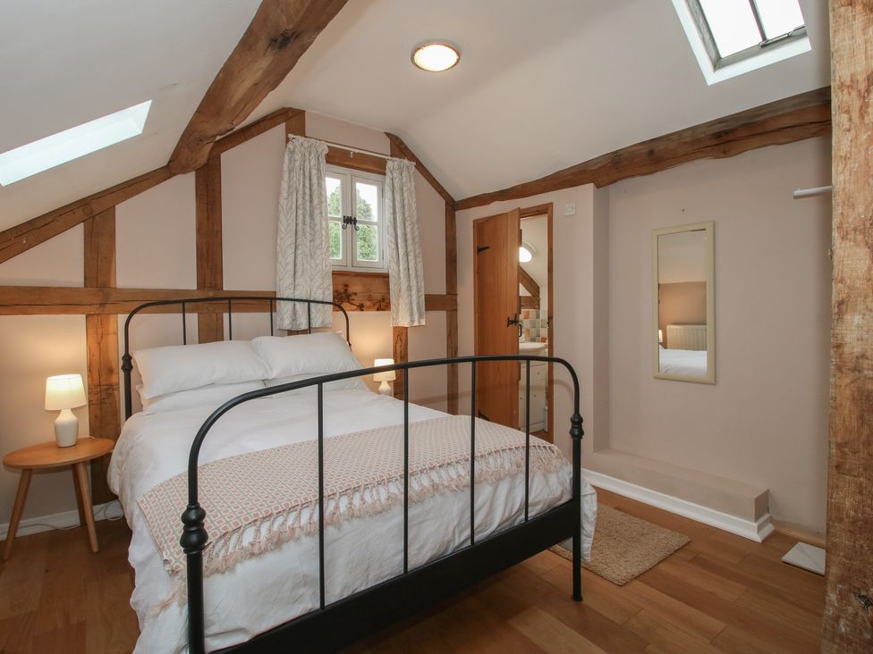 A bedroom with a bed and a nightstand at Malt House