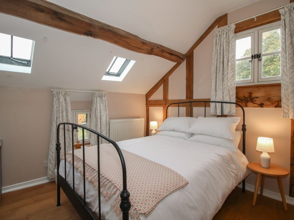 A bedroom with a bed and bedside table at Malt House