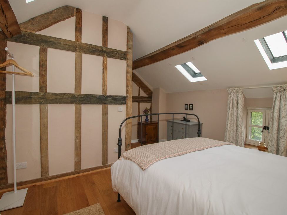 A bedroom with a bed and coat hanger at Malt House 