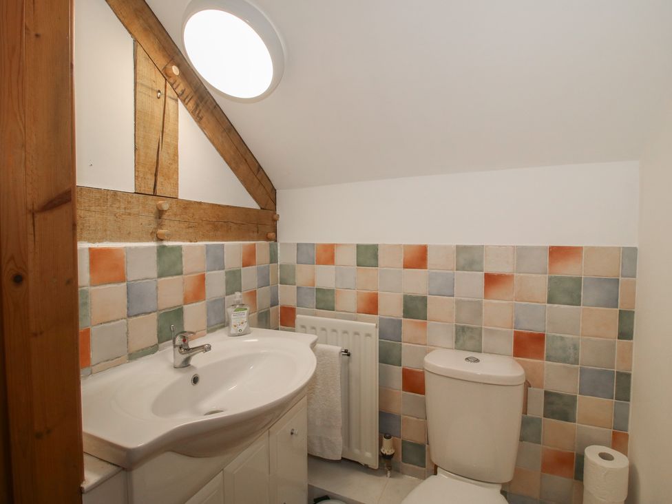 A bathroom with a sink, toilet, and radiator at Malt House