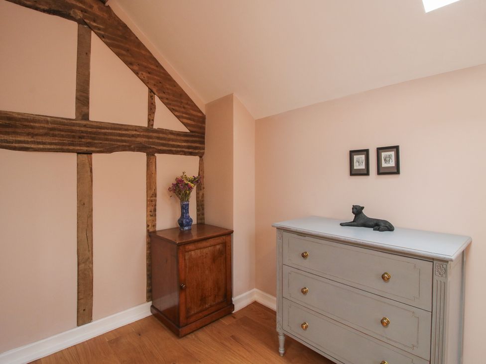 A bedroom with a chest of drawers and cabinet at Malt House