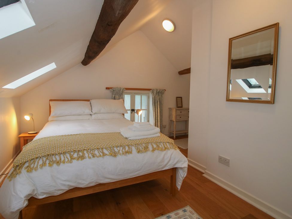 A bedroom with a bed and a dresser at Malt House