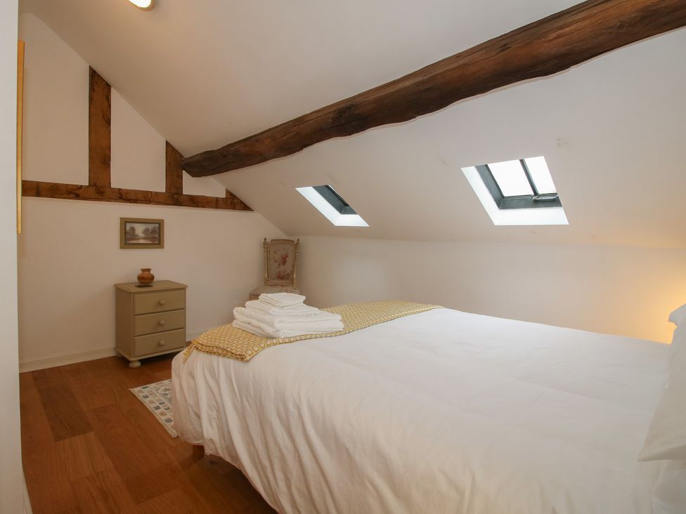 A bedroom with a bed and drawers at Malt House