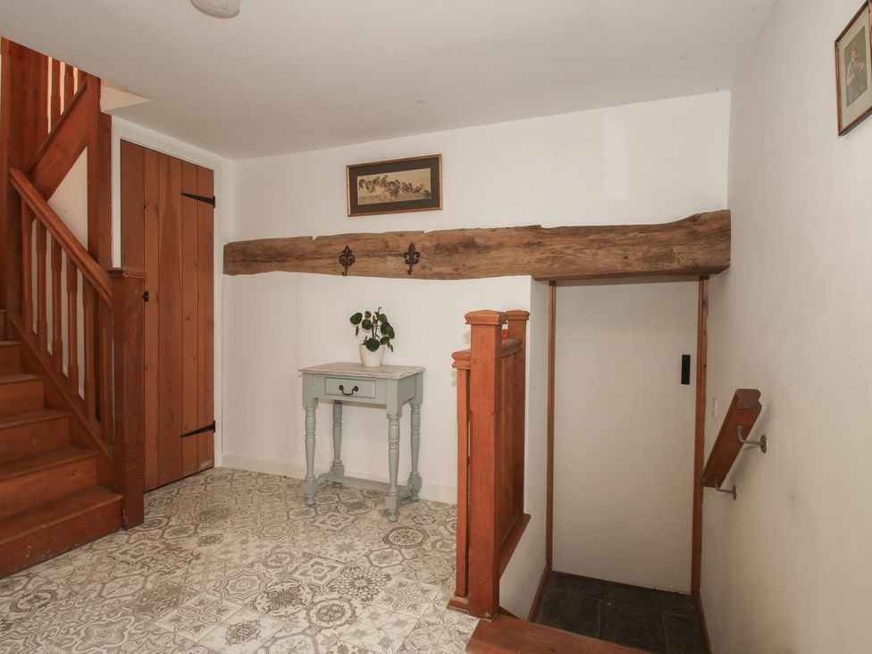 A hallway with stairs and a table at Malt House
