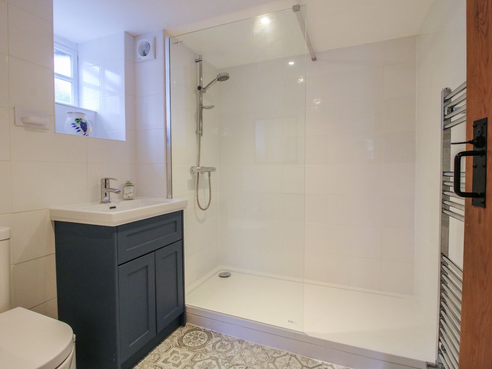 A bathroom with a shower, sink, and toilet at Malt House