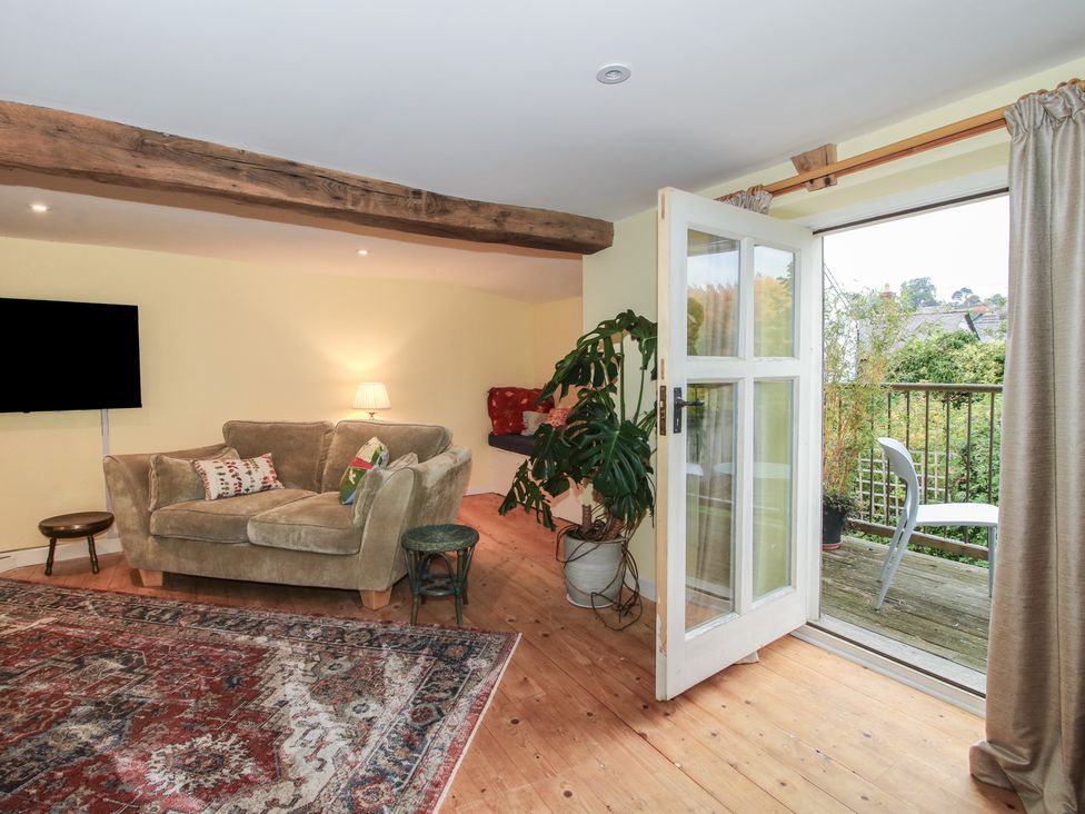 A living room with a sofa and television at Malt House in Bishop's Castle
