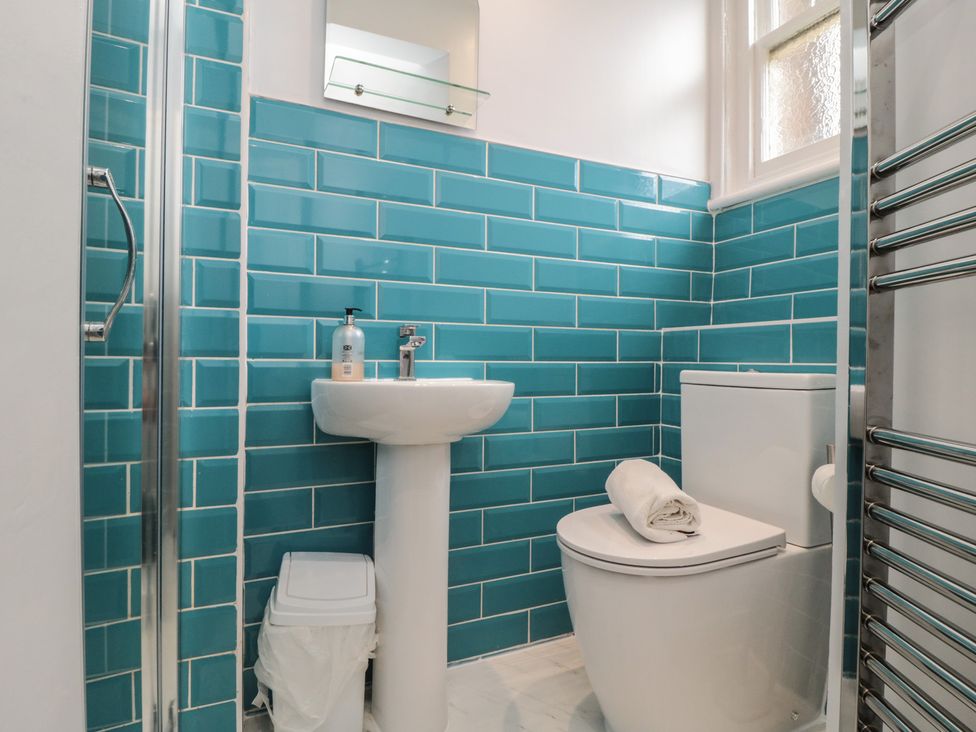 A bathroom with a sink, toilet, and shower at Wellington House in Bridlington