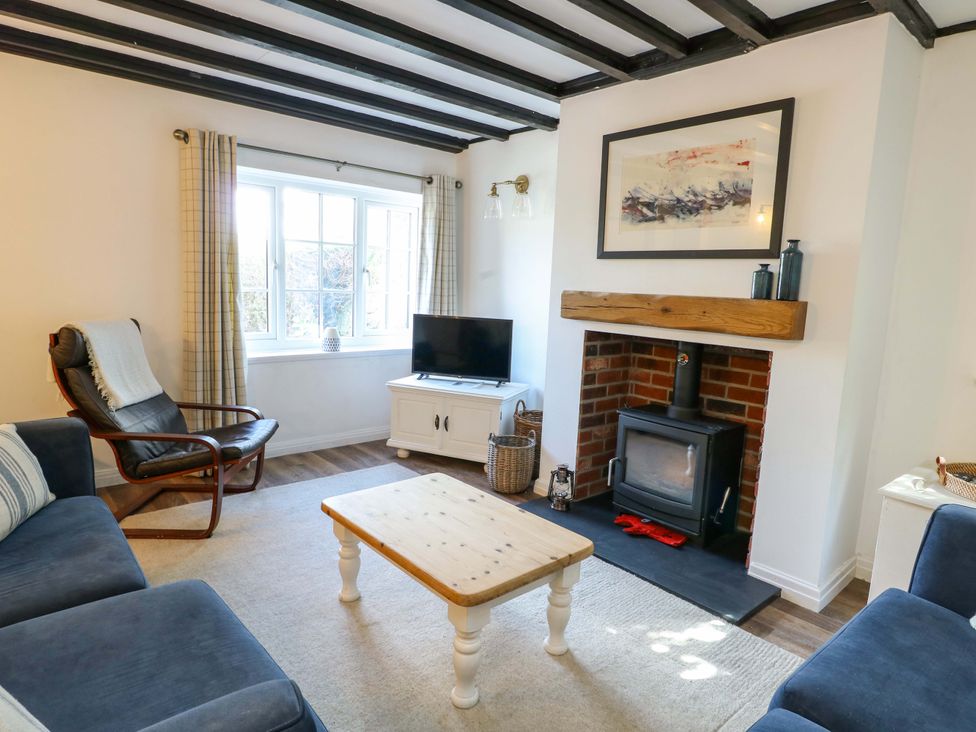 A living room with a television and fireplace at Craig Mawr in Benllech