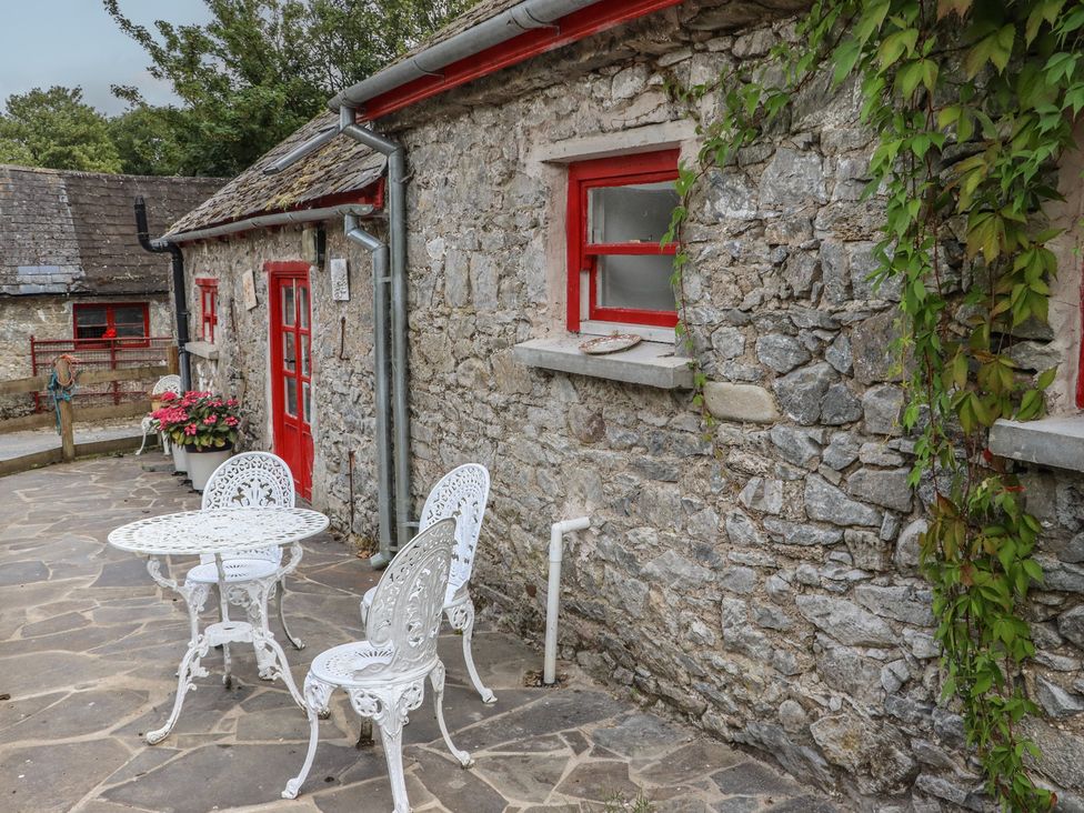 An outdoor seating area with a table and chairs at The Dairy in Ardfinnan, County Tipperary