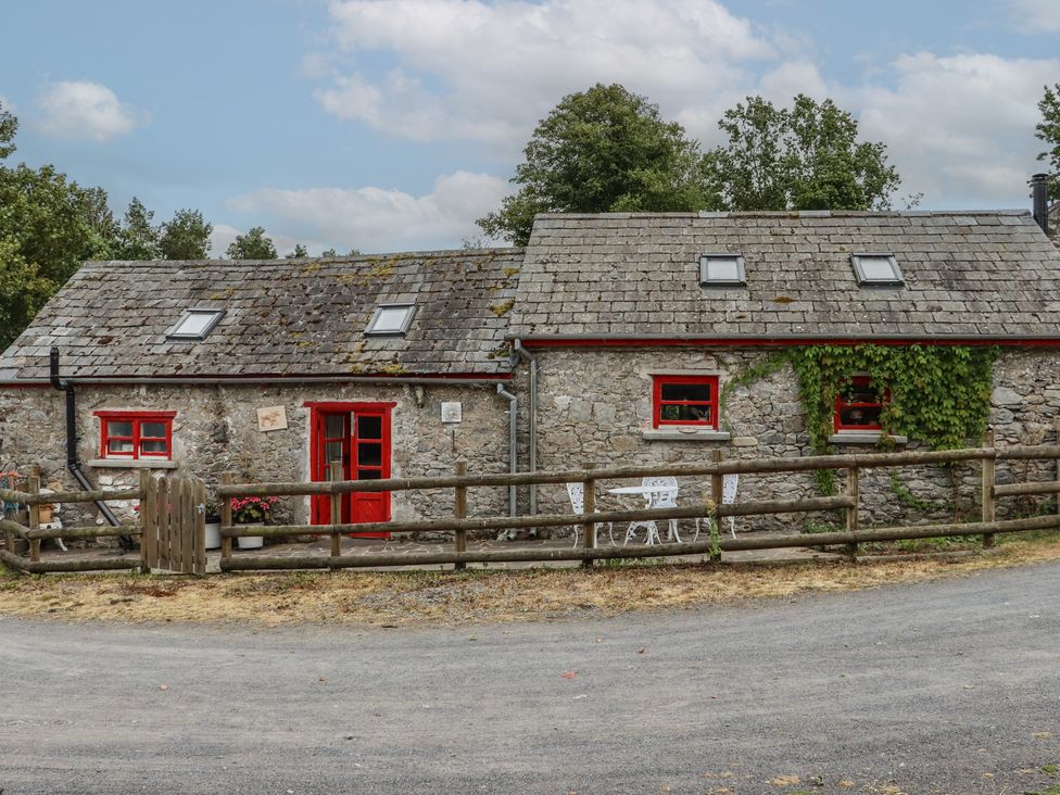 A cottage with red door and windows at The Dairy Ardfinnan, County Tipperary
