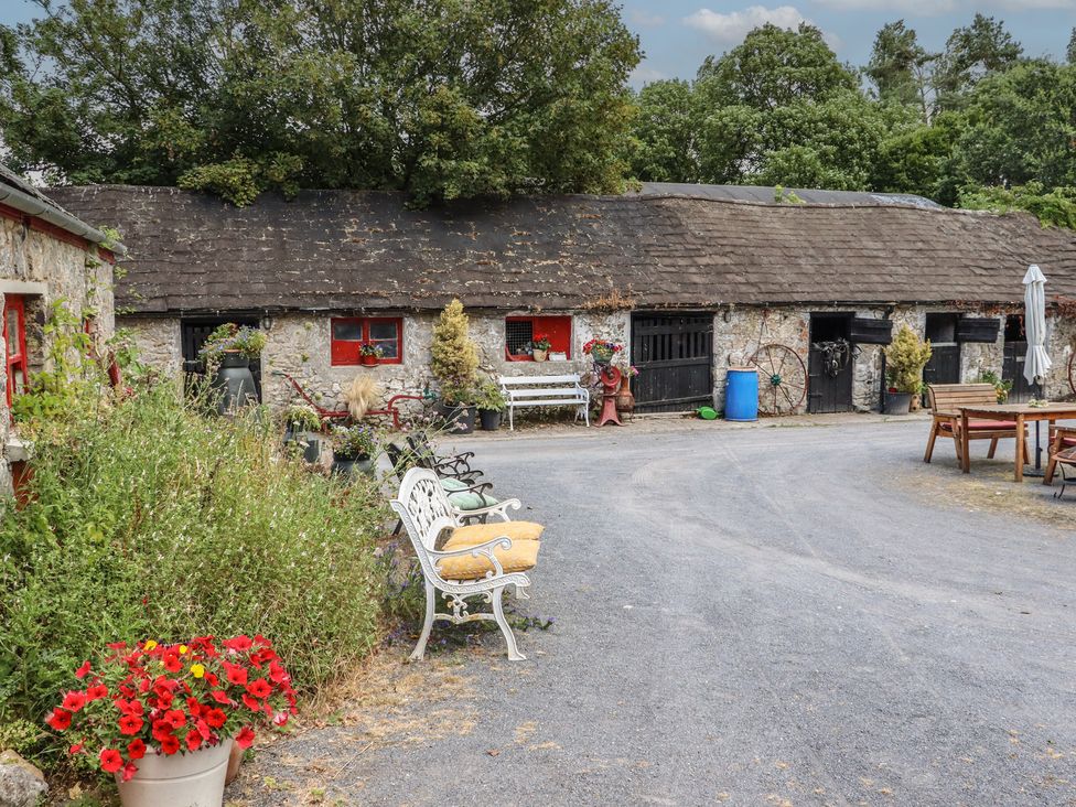 An outdoor area with a building and seating arrangements at The Dairy in Ardfinnan, County Tipperary