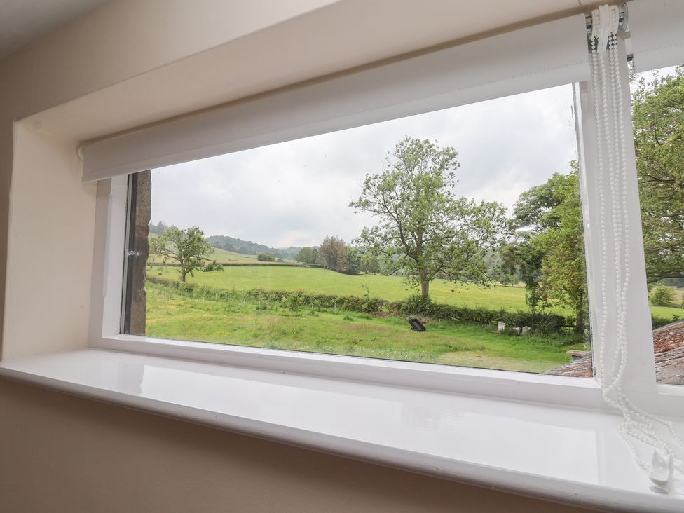 A window with a view of a field and trees at Cliffe House Cottage in 