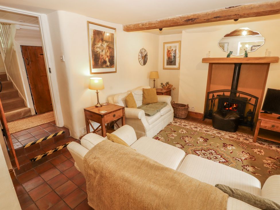 A living room with a fireplace and sofa at White House in Shap