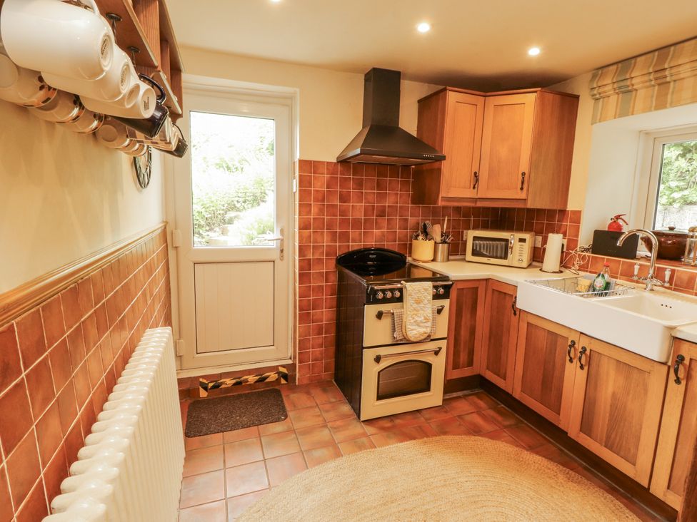 A kitchen with a stove and sink at White House in Shap