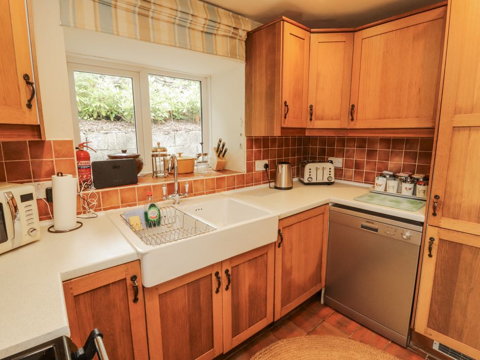 A kitchen with a sink, dishwasher, and countertop at White House in Shap