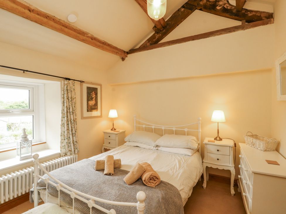 A bedroom with a bed and nightstand at White House in Shap