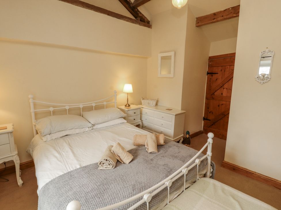 A bedroom with a bed and nightstand at White House in Shap